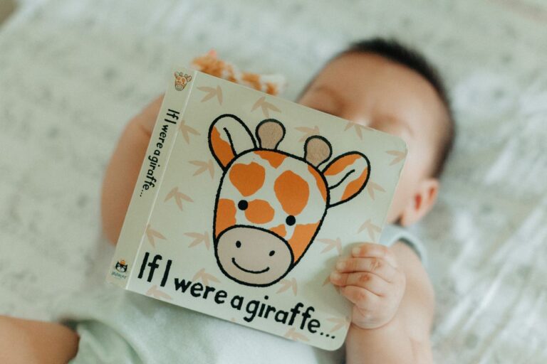 One of the best board books for babies, a newborn looking at a high-contrast board book
