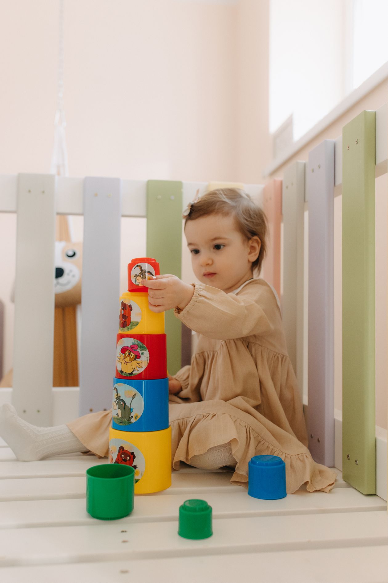 Toddler stacking a wooden Montessori toy tower