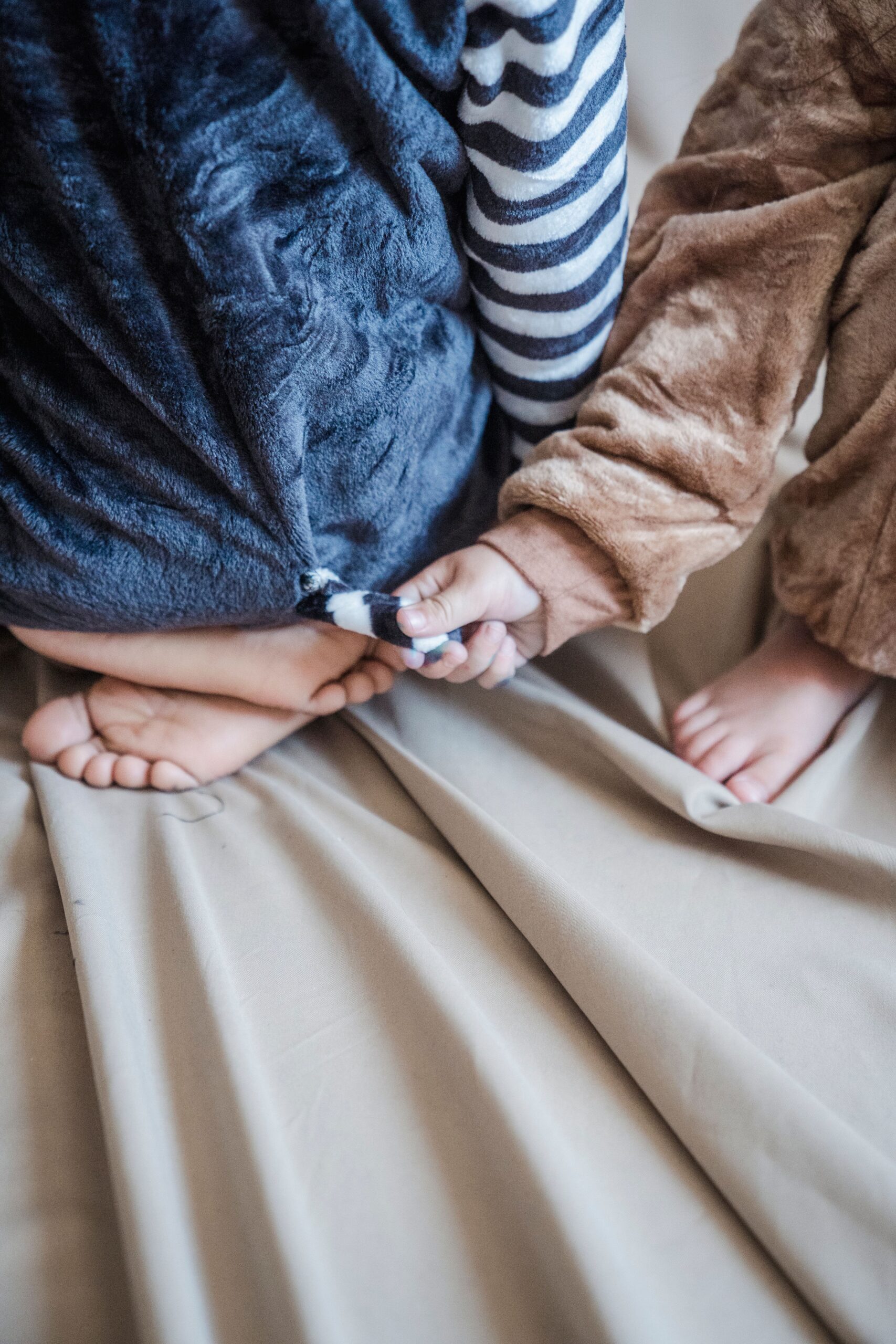 Bamboo vs cotton pajamas: two children sitting together wearing soft pajamas