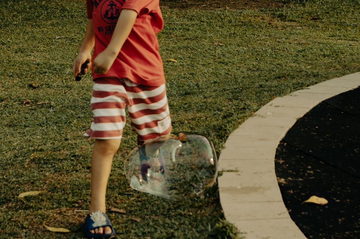 Best sandals for toddlers: a child walking outdoors in sandals near water
