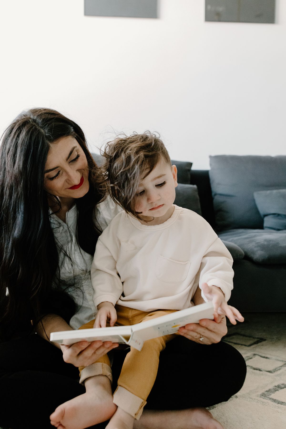Best board books for toddlers: a stack of colorful board books on the floor