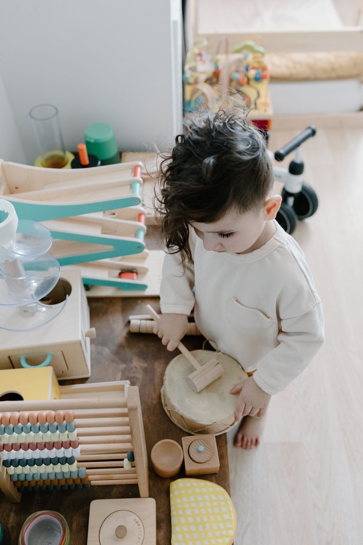 toddler exploring wooden activity toys, part of a toys for 18 month old collection