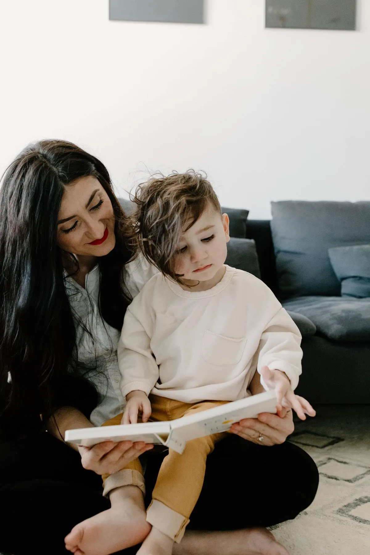 Best board books for toddlers: a stack of colorful board books on the floor