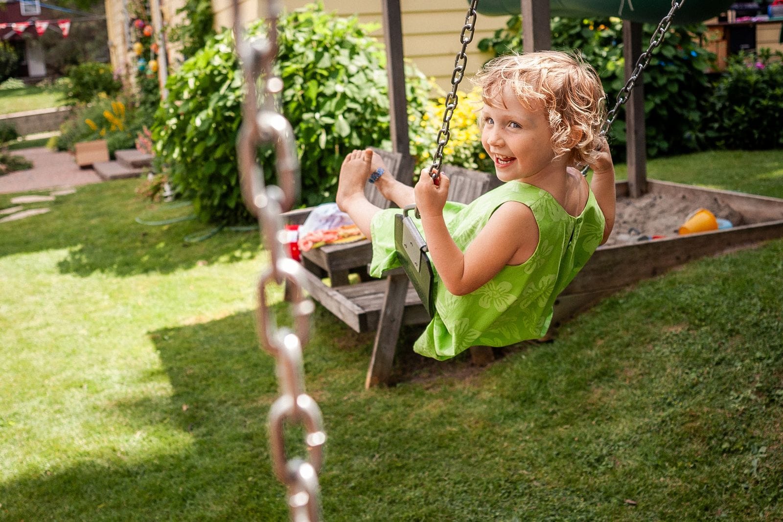 Child swinging outdoors, similar to a DIY kids playground tire swing setup