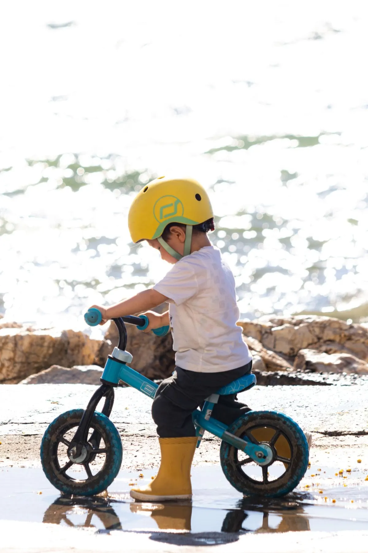 What age is a balance bike for: toddler riding a 12 inch balance bike outdoors
