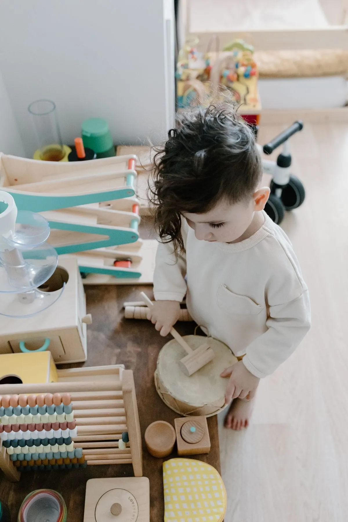 toddler exploring wooden activity toys, part of a toys for 18 month old collection